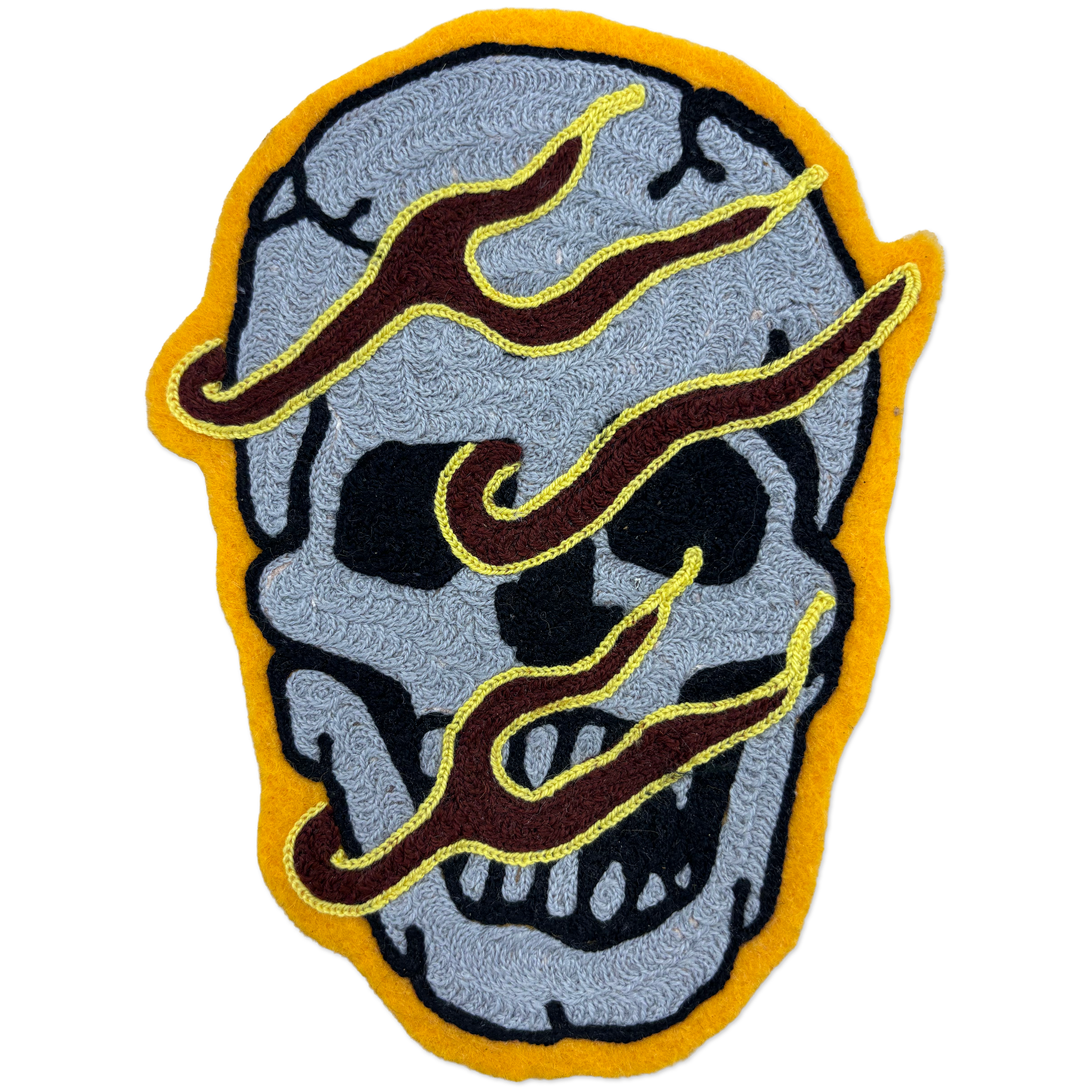 Hand-made chainstitch patch depicting a flaming skull.