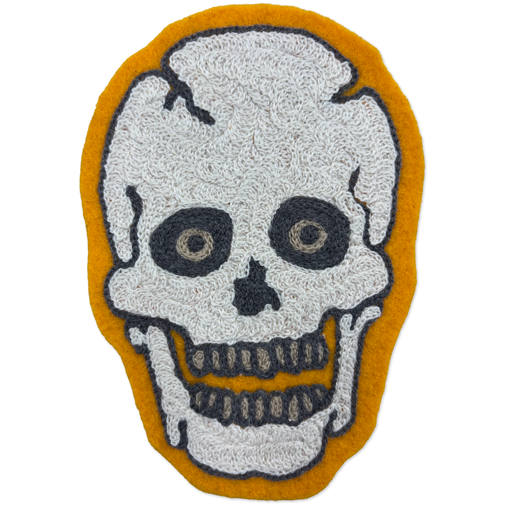 A skull-shaped chainstitch patch with a textured white skull design outlined in black, set against a mustard yellow background.