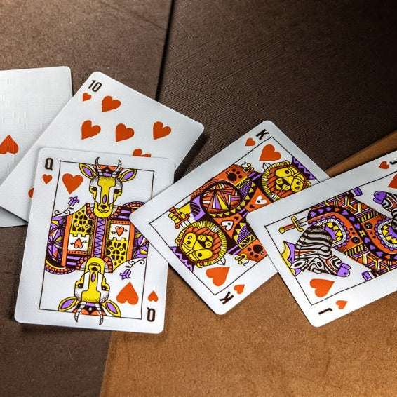 Colorful playing cards with animal designs on a brown surface
