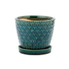 Teal ceramic planter with textured design on a white background