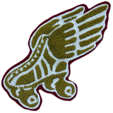 A textured, tufted patch featuring a stylized winged figure in olive green, white, and dark burgundy, isolated on a white background.
