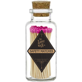 Glass jar with cork lid containing pink-tipped safety matches branded 'The Lost Wax Co'.