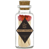 Glass jar with cork lid containing red safety matches branded 'The Lost Wax Co'.