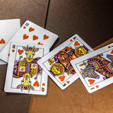 Colorful playing cards with animal designs on a brown surface