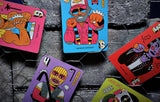 Colorful card designs with cartoon characters on a textured surface