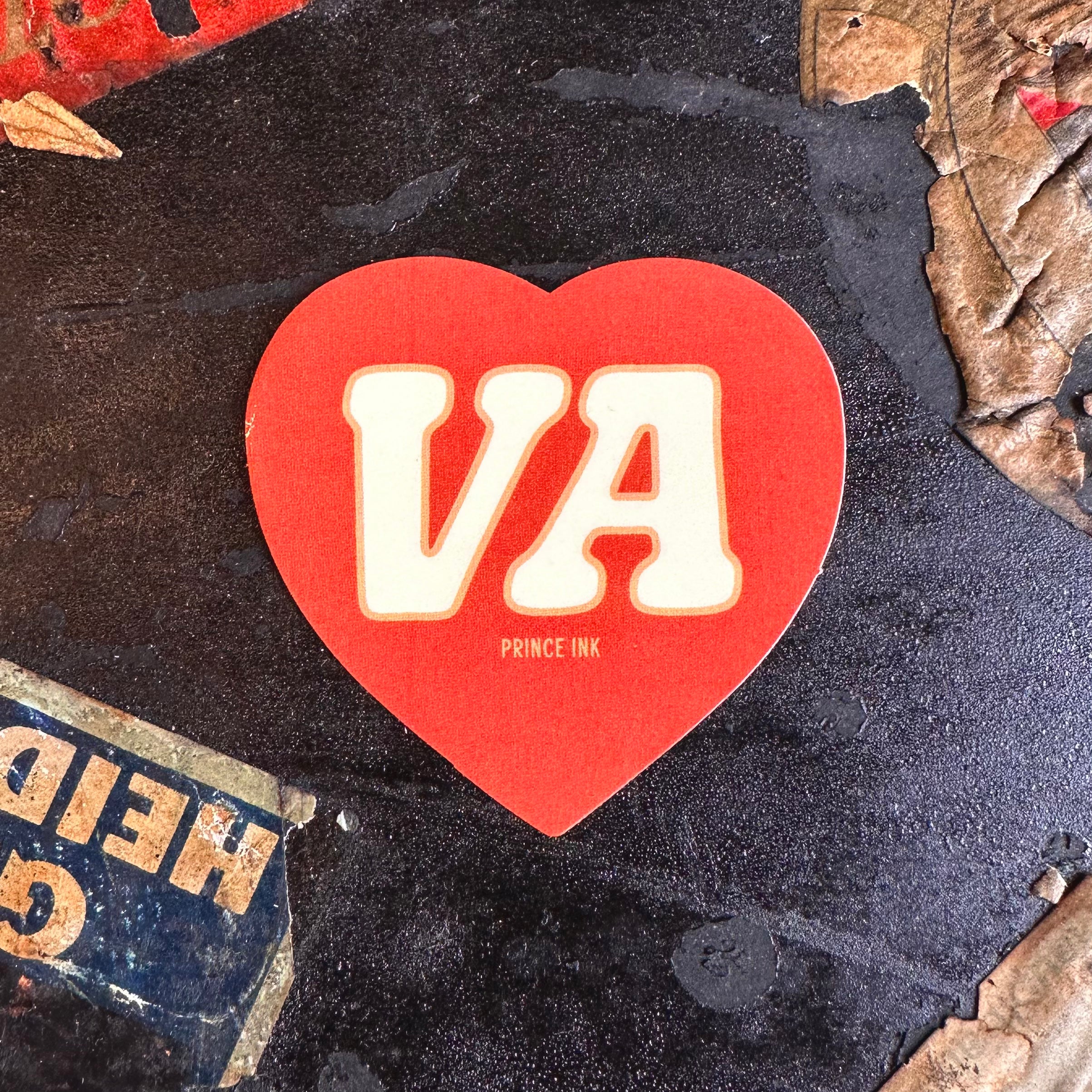 Red heart-shaped sticker with VA in white, and a small Prince Ink printed below