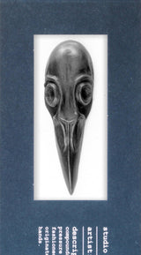 Decorative black graphite bird skull with a long beak on a white background
