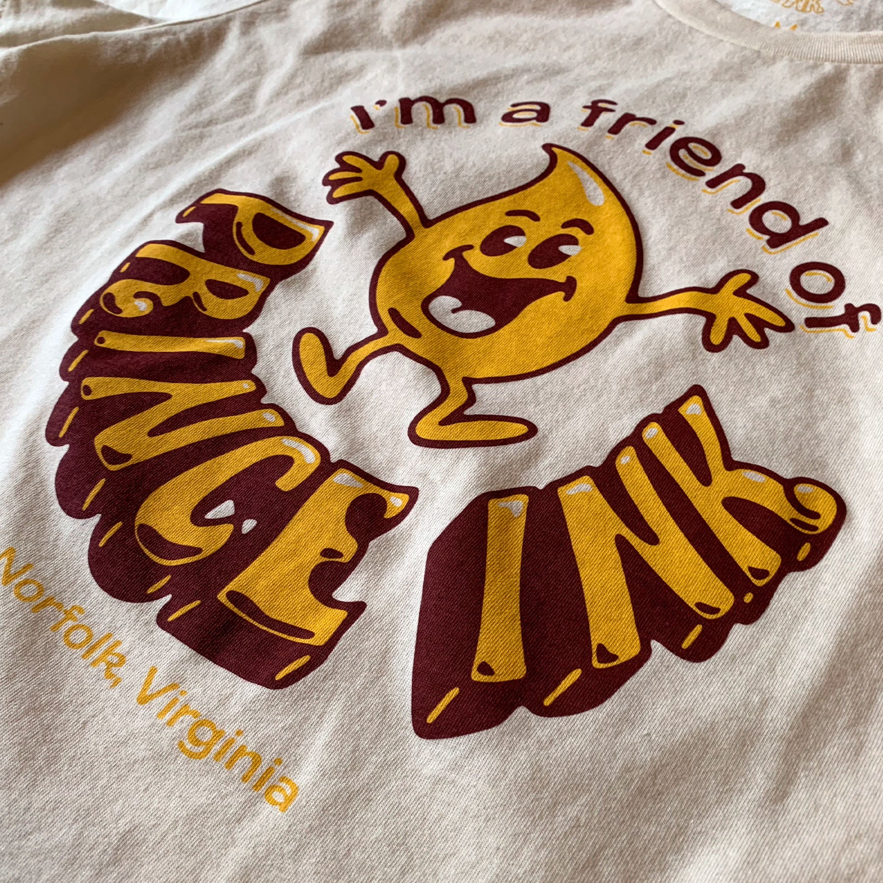 Closeup of t-shirt with yellow and brown retro graphic